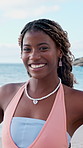 Face, beach and happy black woman on vacation, summer holiday and laugh on tropical island. Portrait, funny and African person at ocean for travel, tourism and outdoor adventure with trip in Nigeria