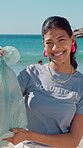 Face, volunteer and woman with trash bag at beach, plastic collection or environment sustainability. Seaside, community service or person with pride for litter cleaning project, eco activist or smile