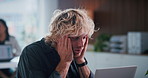 Bored, stress and man in office with laptop for creative project with deadline at startup business. Fatigue, computer and male magazine editor with burn out for article with publishing in workplace.