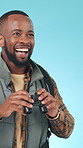 Binoculars, smile and surprise with black man in studio for bird watching hobby, reaction or search. Adventure, travel and wow with excited African person on blue background for avian observation