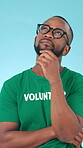 Volunteer, thinking and black man in studio with decision, social responsibility and eco friendly idea. Charity worker, person and reflection with NGO, sustainability and outreach on blue background.