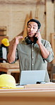 Phone call, argument and carpenter with laptop in workshop for delivery information with furniture for repairs. Cellphone, upset and male woodworker on mobile discussion for late timber delivery.