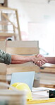 Carpentry, laptop or hands in factory with handshake, greeting or collaboration in DIY project. Networking, people or carpenters with tech, contractor agreement or introduction in partnership deal.