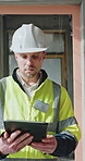 Tablet, man and construction worker on site for inspection for building, renovation or repairs. Notification, reading and male civil engineer with digital technology for email or communication.