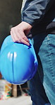 Hand, architecture and man with helmet for safety, construction site or building project. Walking, person or employee with hard hat for protection, engineering compliance or inspection for renovation