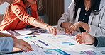 Business people, meeting and pointing with hands on documents for team analysis, performance review. Group, employees or collaboration with paperwork, graph or chart for plan, statistics or analytics