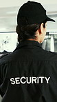 Woman, security and surveillance with computer footage for safety protocol or protection service. Back view, female person or body guard monitoring video for CCTV investigation in control room
