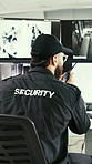 Man, security and consultant with radio for surveillance or protection service in control room. Back view, male person or body guard talking with signal for neighborhood watch or tactical response
