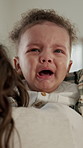 Home, mother and comfort crying baby for soothing, infant behavior and discomfort with teething. Affection, mom and console emotional kid in apartment with swaddle, hungry boy and child development