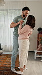 Dancing, pregnant woman and couple holding hands in home together, bonding and trust for connection. Love, maternity support and happy people with fun for healthy relationship, care and romance