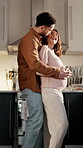 Dance, couple and pregnant woman with kiss in kitchen together, bonding and affection for connection. Home, maternity support and happy people with care for healthy relationship, love and touch tummy