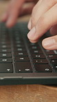 Hands, keyboard and typing with person at desk in office for development, planning or research. Fingers, laptop and report with employee man at table in workplace for administration or online review