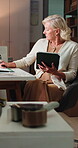 Logistics, tablet and writing with woman in office for delivery, distribution or shipment tracking. App, notebook and supply chain with mature courier in warehouse for shipping management or service