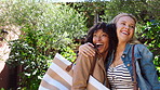 Happy women, friends and hug with love for holiday getaway, travel or vacation together in nature. Excited, female people or embrace with smile for outdoor trip, check in or stay in natural resort