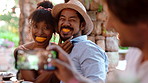 Funny, phone and photograph with couple at restaurant together for dinner party or reunion. App, memories and picture of playful people with orange in mouth for fine dining or social gathering