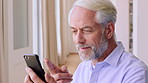 Phone, blow kiss and happy man with video call in home, communication and wave for goodbye. Virtual farewell, speaking or mature person with mobile for connection, networking or gesture for affection