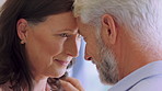 Old couple, happy and touch with forehead in home for bonding, connection and love in retirement. Elderly man, woman and partner with smile, relationship and affection with trust at apartment