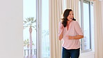 Window, dancing and woman with music in house for weekend break, energy and groove for entertainment. Flare, carefree and mature person with radio track for happiness, apartment and moving to rhythm