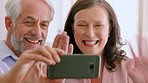 Smartphone, wave and happy couple with video call in home, networking and greeting for communication. Virtual chat, mobile and mature people with gesture for hello, connection and listening to story