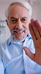 Video call, wave and face of senior man in home for communication, talking and connection. Happy, hello and portrait of elderly person with greeting for online conversation, networking and chat