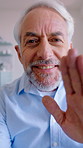 Face, wave and mature man on video call, talking and blow kiss for communication with contact. Portrait, virtual chat and happy person with hand gesture for love, greeting or hello with POV in home