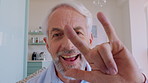 Happy, face and senior man on video call with sign language for communication, contact or chat. Retirement, home and portrait of elderly person with I love you gesture for connection and conversation
