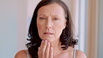 Skincare, check and face of woman in home for anti aging, morning routine and collagen glow. Self care, dermatology and grooming with mature person in apartment for facial results, touch and shine