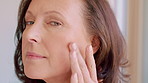Skincare, touch and face of woman in home for anti aging, morning routine and collagen glow. Self care, dermatology and grooming with mature person in apartment for facial results, check and shine
