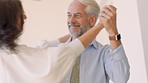 Home, love and mature couple dance for anniversary celebration, bonding together and smile. Man, woman and moving to music in house with partner for connection, romance and holding hands with freedom