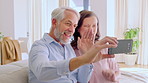 Elderly, couple and wave with phone for video call, communication or goodbye on sofa in home. Senior, man and woman with farewell or good news on mobile smartphone for virtual chat or app in house