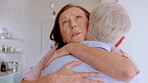 Sad, couple and comfort with hug in home for bad news, emotional support and empathy for grief. Unhappy, mature people and embrace with sorrow in kitchen for loss, compassion and console for mourning