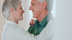 Dancing, happy and old couple in home with hug, romantic love and bonding together for anniversary. Music, senior people and embrace in house with retirement, care or support for marriage commitment.