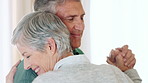Dancing, happy and old couple in house with holding hands, love or bonding together for anniversary. Music, senior people and hug in home with retirement, support or romantic for marriage commitment.