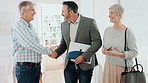 Handshake, couple and real estate agent with keys to new home for property sale, purchase or picture. Moving, mature buyers and realtor shaking hands for ownership transfer, mortgage success or photo