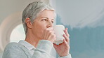 Thinking, coffee and senior woman in home to start day with beverage, comfort and wellness in morning. Retirement, house and mature person with tea, drink and calm for reflection, thoughtful or peace