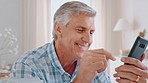 Senior, happy man and laughing with phone in home for funny joke, social media or online joke. Elderly, male person or comedy with smile on mobile smartphone for humor, web browsing or app in house