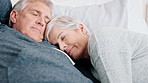 Cuddle, nap and senior couple in bed for resting together, comfortable and relax in afternoon. Retirement, home and mature man and woman in bedroom for sleeping, bonding and peaceful in relationship