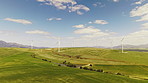 Wind turbine, renewable energy or grass field with drone for economic development in nature. Aerial view, windmill or power with eco friendly environment for alternative resource in countryside