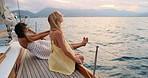 Travel, sunset and friends on yacht in ocean for vacation, tropical adventure and tourist destination. Relax, nature and women on boat for cruise, journey and explore islands on summer holiday