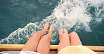 Women, legs and relax with boat at sea for outdoor travel, holiday or trip together on ocean above. Top view, female people or friends feet with waves, wind or water on ship for weekend vacation