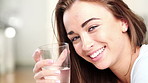 Happy woman, face and drinking with water in home for healthy diet, nutrition or detox. Portrait, female person or smile with mineral liquid or glass of vitamins for thirst, refreshment or hydration