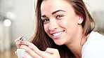 Happy woman, face and eating with fruit bowl in home for nutrition, vitamins or healthy breakfast. Portrait, female person or smile with natural organic food for morning snack, diet or meal in house