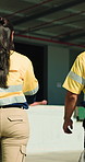 Back, people and walking by warehouse with logistics, discussion and planning for cargo distribution. Team, collaboration and outdoor at depot with advice, supply chain update and shipping feedback.