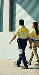 Logistics, people and walk by warehouse with supply chain update, discussion or plan for distribution. Team, talk and outdoor at depot with shipping operations, export and collaboration for dispatch.