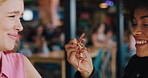 Happy women, friends and laughing with food in cafe for bonding, feeding or humor together. Playful, female people or smile with seafood snack or meal for funny dining experience at indoor restaurant