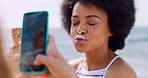 Picture, holding phone and friends at ocean with ice cream, pout or digital memory on influencer vacation. Playful, happy or people with cone, social media update or content creation on seaside trip.