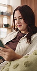 Streaming, happy or woman in living room with tablet, online reading or video browse on social media. Laugh, multimedia or person in house with tech, ebook subscription or digital scroll in free time