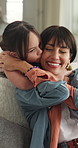 Mom, child and kiss in home for love, relax and hug together with parent for happiness. Mother, girl and embrace in living room with kid for connection, trust and support for care with daughter
