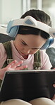 E learning, headphones or child in house with tablet, online activity or project on academic platform. Homeschool, tech or girl on sofa with homework, digital lesson or assessment in remote education