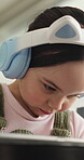 E learning, headphones or child in home with tablet, online activity or project on academic platform. Homeschool, tech or girl on sofa with homework, digital lesson or assessment in remote education.